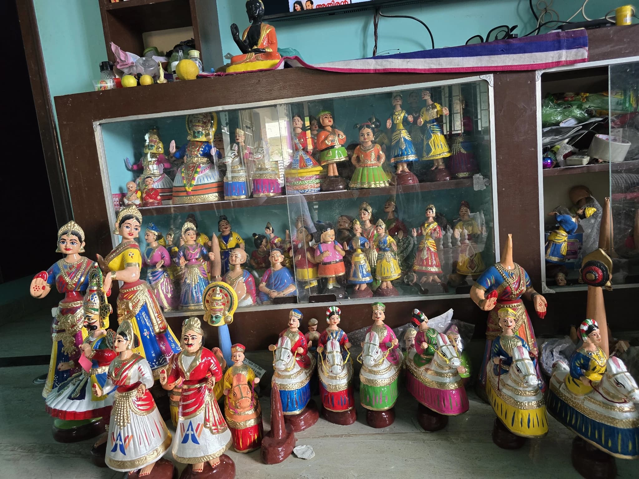 Shelves full of colourful finished Thanjavur dancing dolls